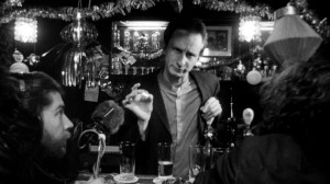 making the film crew a drink, like any proper serial killer host should do 